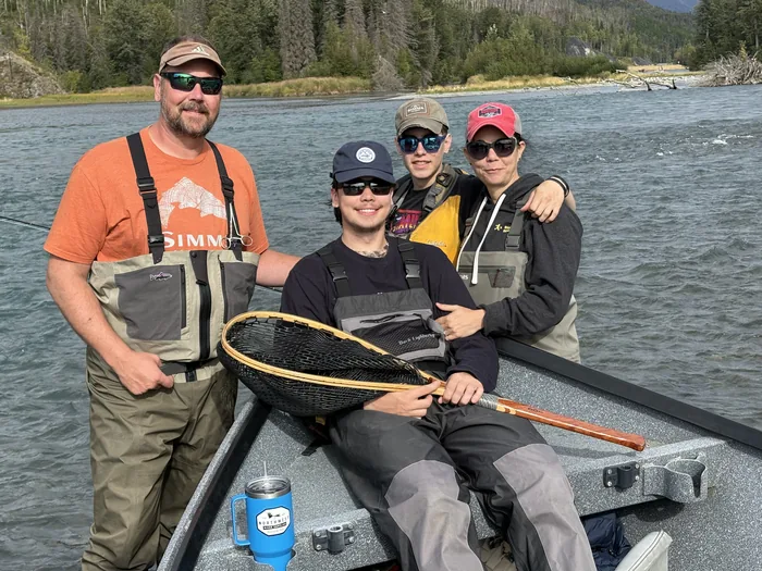 The Wall family fishing from a drift boat on an Alaska river