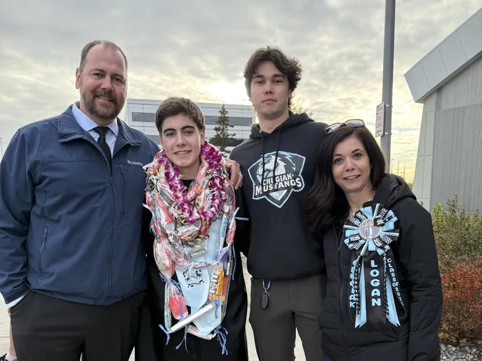 Gina and Doug Wall with their sons Jackson and Logan at graduation