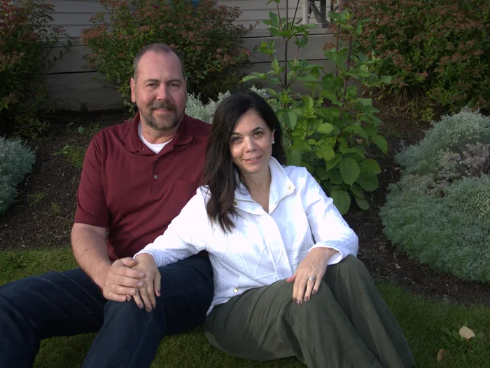 Gina and Doug Wall sitting in the garden at home