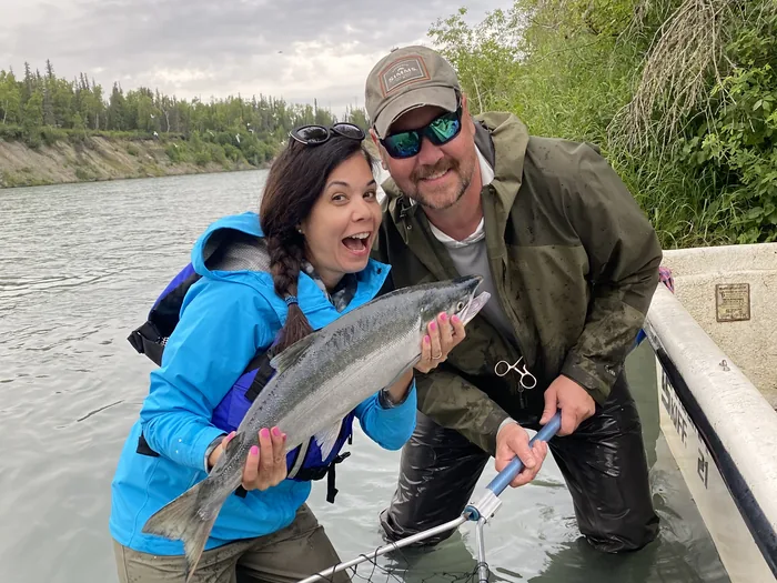 Gina and Doug Wall netting a red salmon together