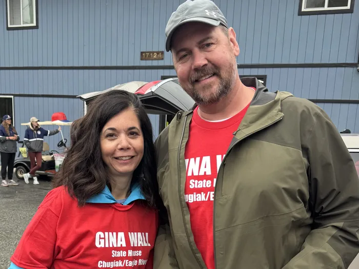 Gina and Doug Wall in red Gina Wall campaign shirts at a district event